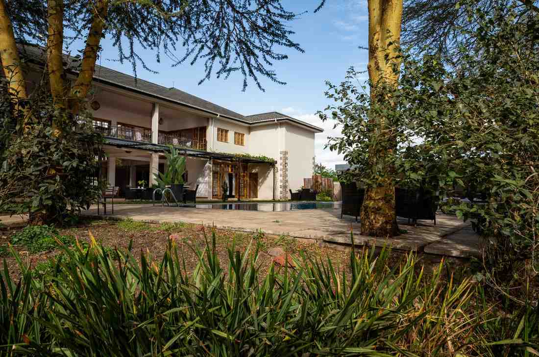 Kahawa House plantation-style room balcony overlooking garden and pool