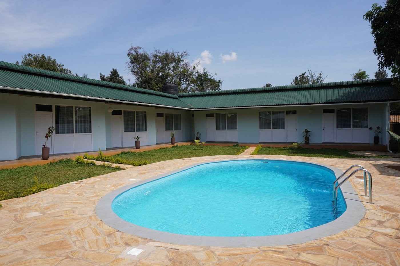 Outdoor swimming pool and sun terrace at Karanga River Lodge near Moshi