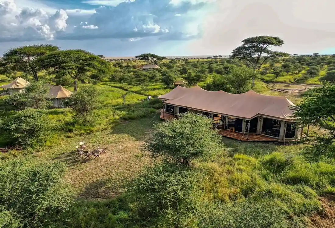 Olmara Camp β raised canvas tent and private deck with Serengeti plains view